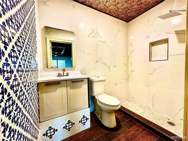 a bathroom with a sink toilet and shower
