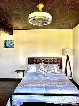 a bedroom with a bed and a painting on the wall