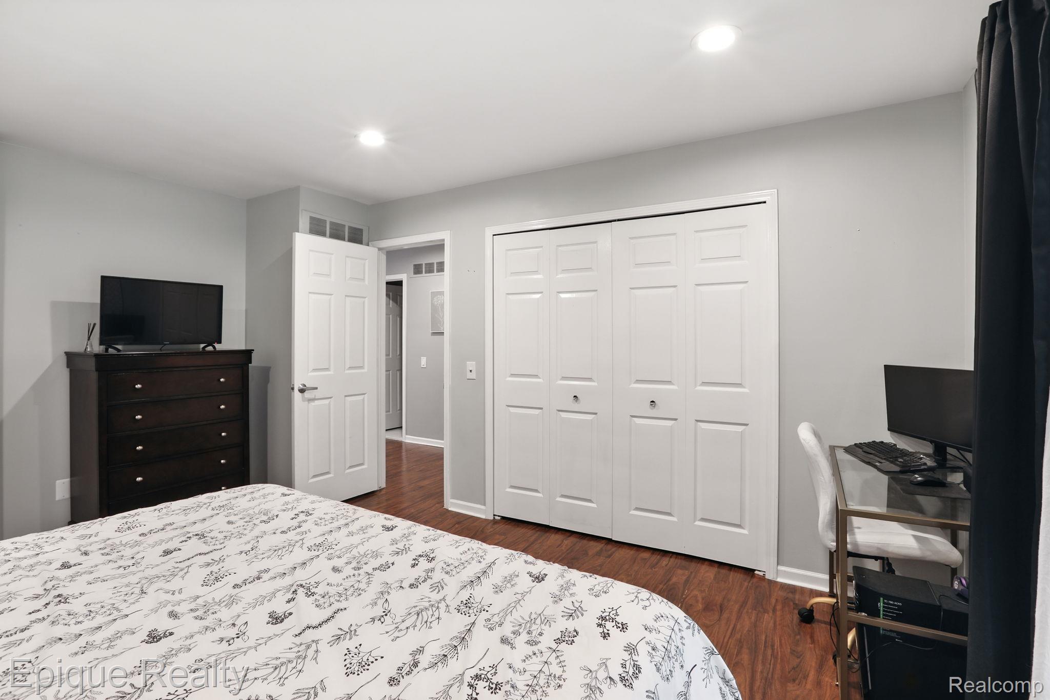 8529 22 Mile Road Utica, MI 48317 - Photo 29 of 40 Bedroom with dark wood-style floors, recessed lighting, a closet, and an office area