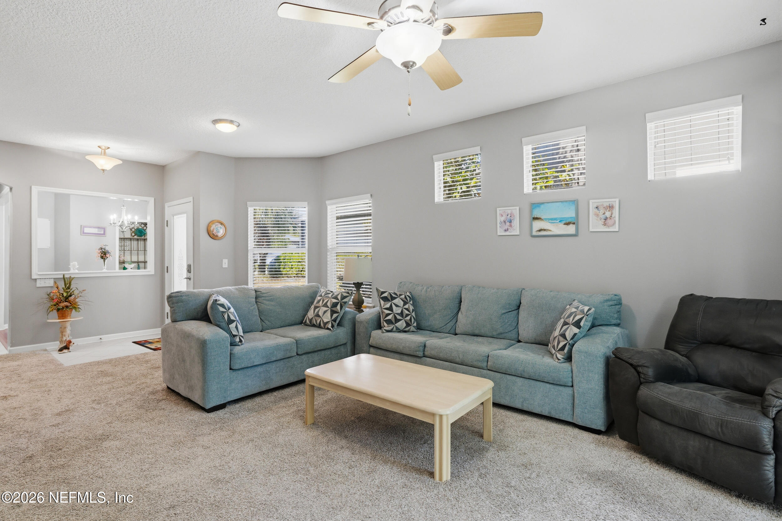 3260 Chestnut Ridge Way Orange Park, FL 32065 - Photo 14 of 39 a living room with furniture and a chandelier