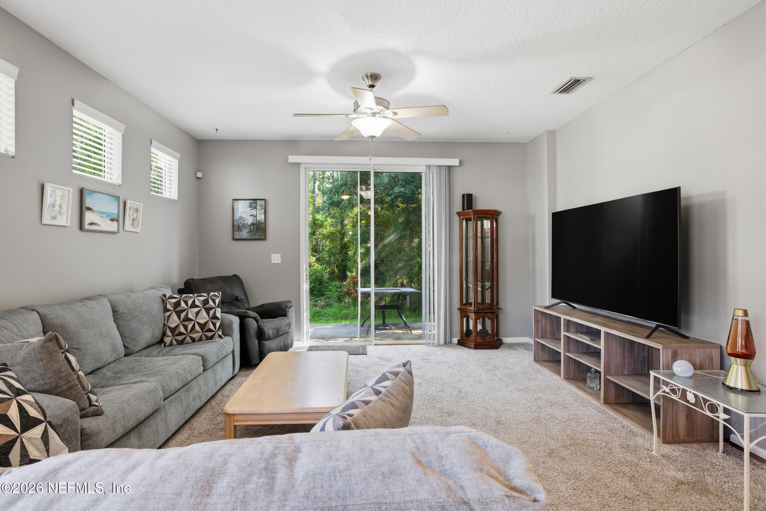 3260 Chestnut Ridge Way Orange Park, FL 32065 - Photo 16 of 39 a living room with furniture and a flat screen tv