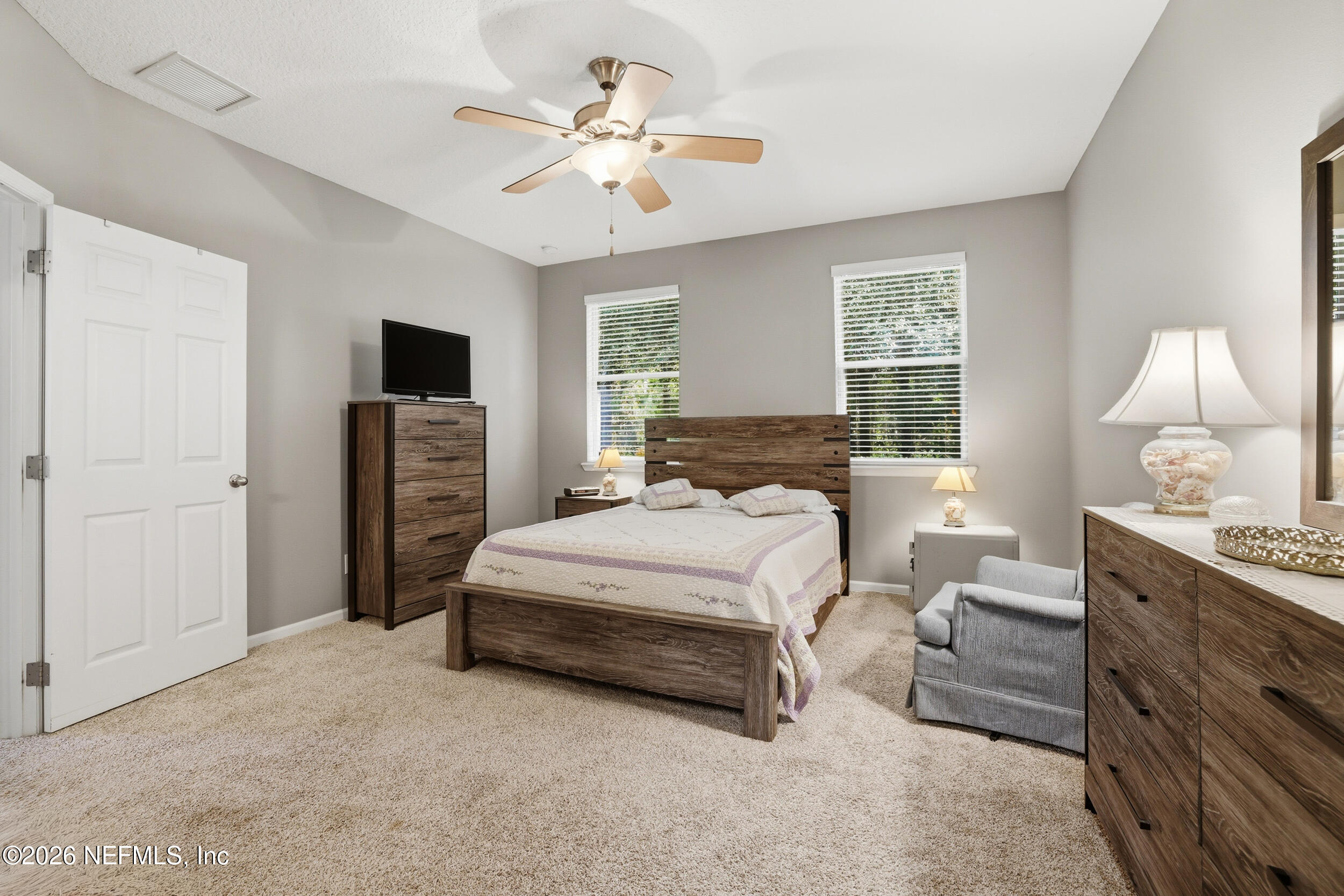3260 Chestnut Ridge Way Orange Park, FL 32065 - Photo 18 of 39 a bedroom with a bed and a chandelier