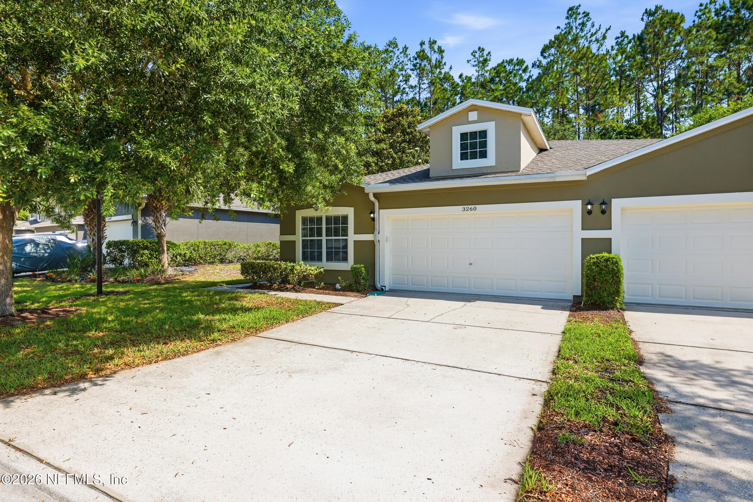 3260 Chestnut Ridge Way Orange Park, FL 32065 - Photo 2 of 39 a front view of a house with a yard and garage