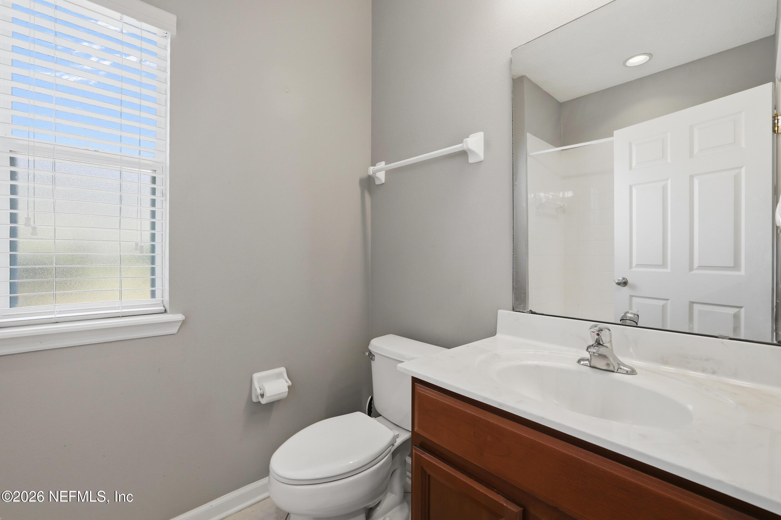 3260 Chestnut Ridge Way Orange Park, FL 32065 - Photo 22 of 39 a bathroom with a granite countertop sink a toilet and a mirror