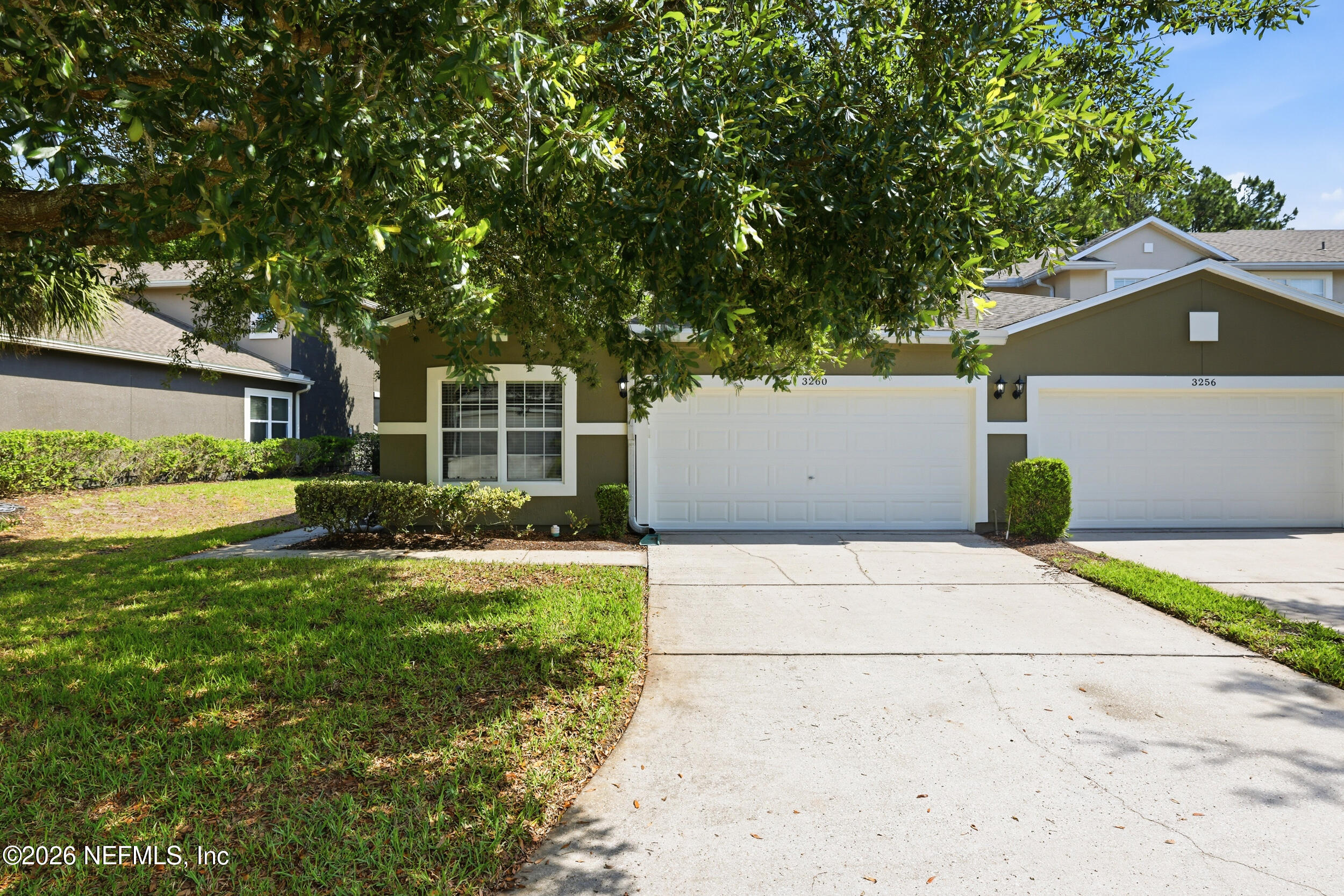 3260 Chestnut Ridge Way Orange Park, FL 32065 - Photo 3 of 39 a front view of a house with garden