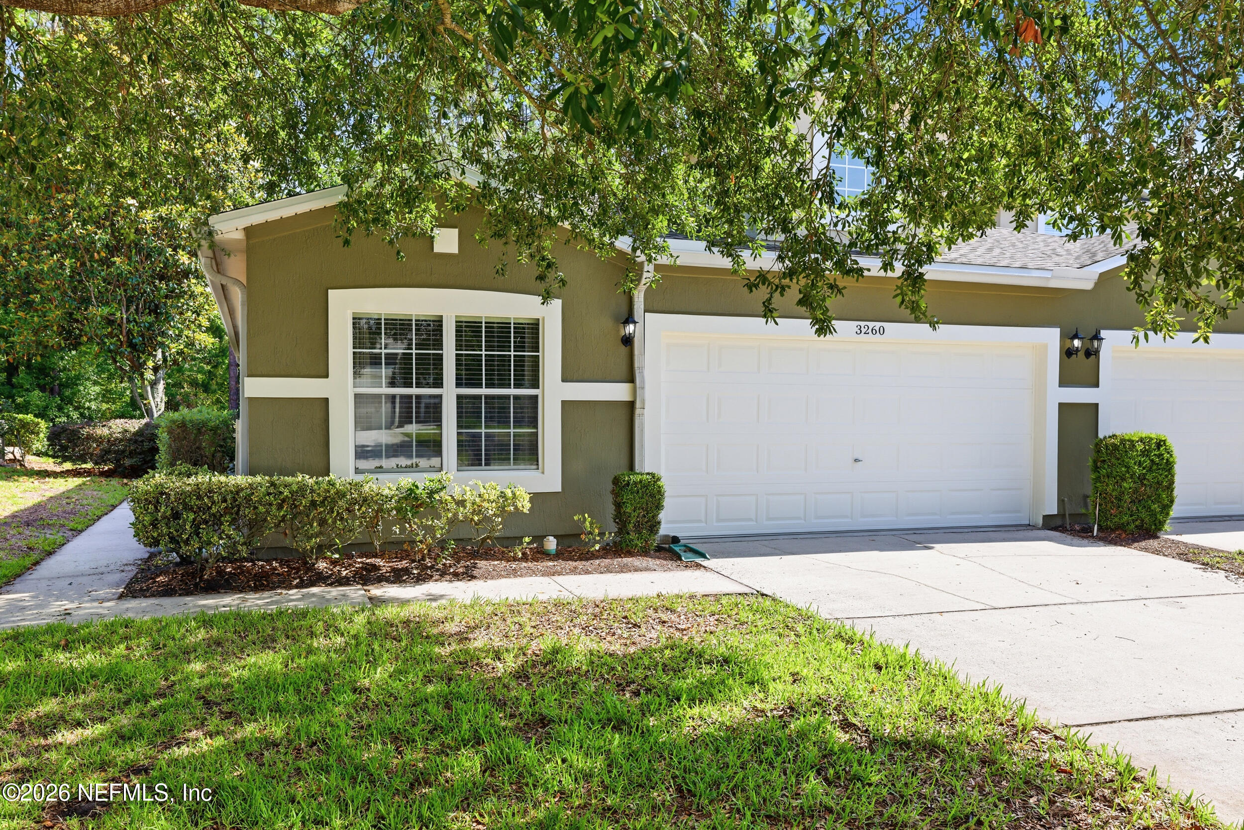 3260 Chestnut Ridge Way Orange Park, FL 32065 - Photo 4 of 39 a front view of a house with a yard and garage