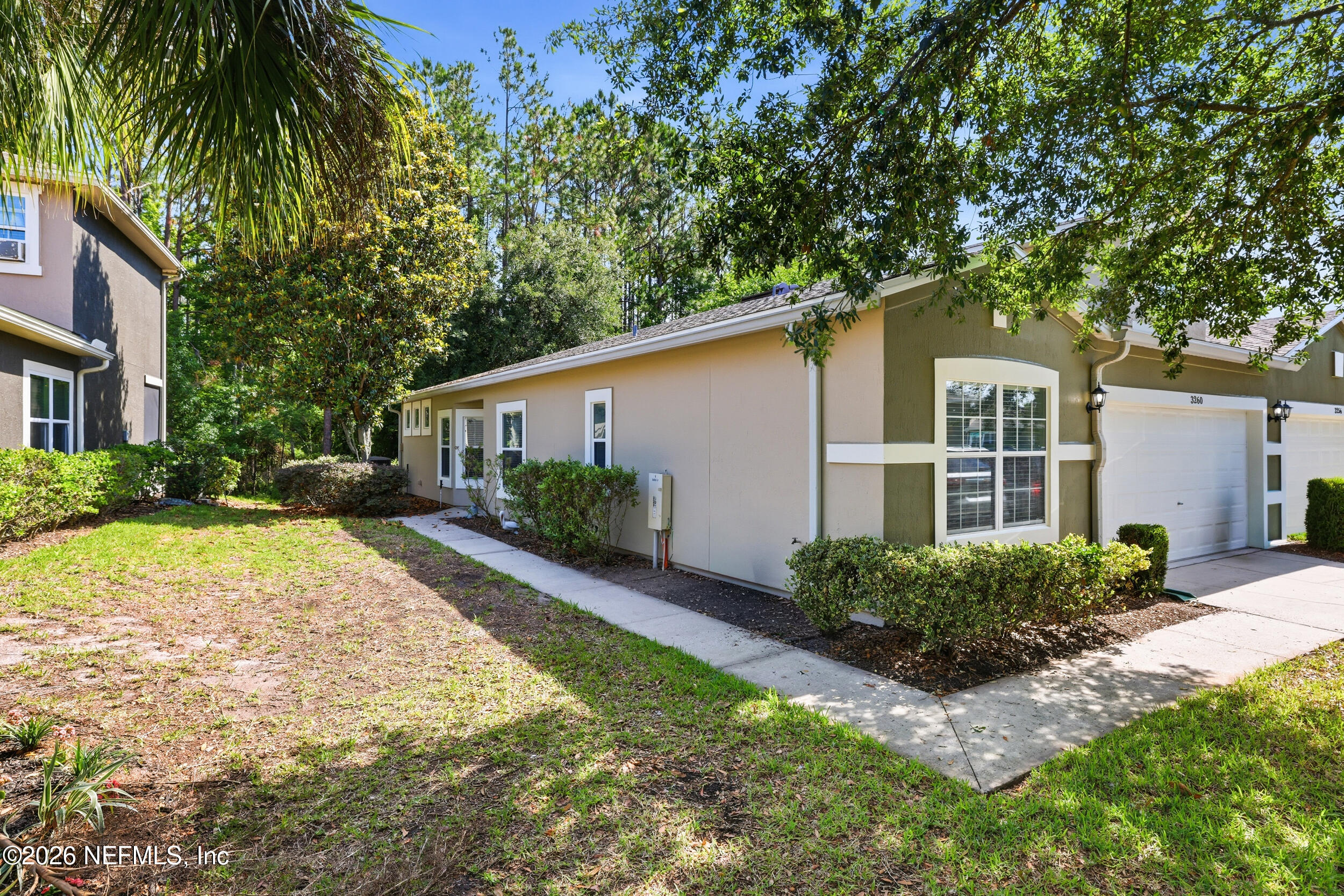 3260 Chestnut Ridge Way Orange Park, FL 32065 - Photo 5 of 39 a front view of a house with a yard and trees