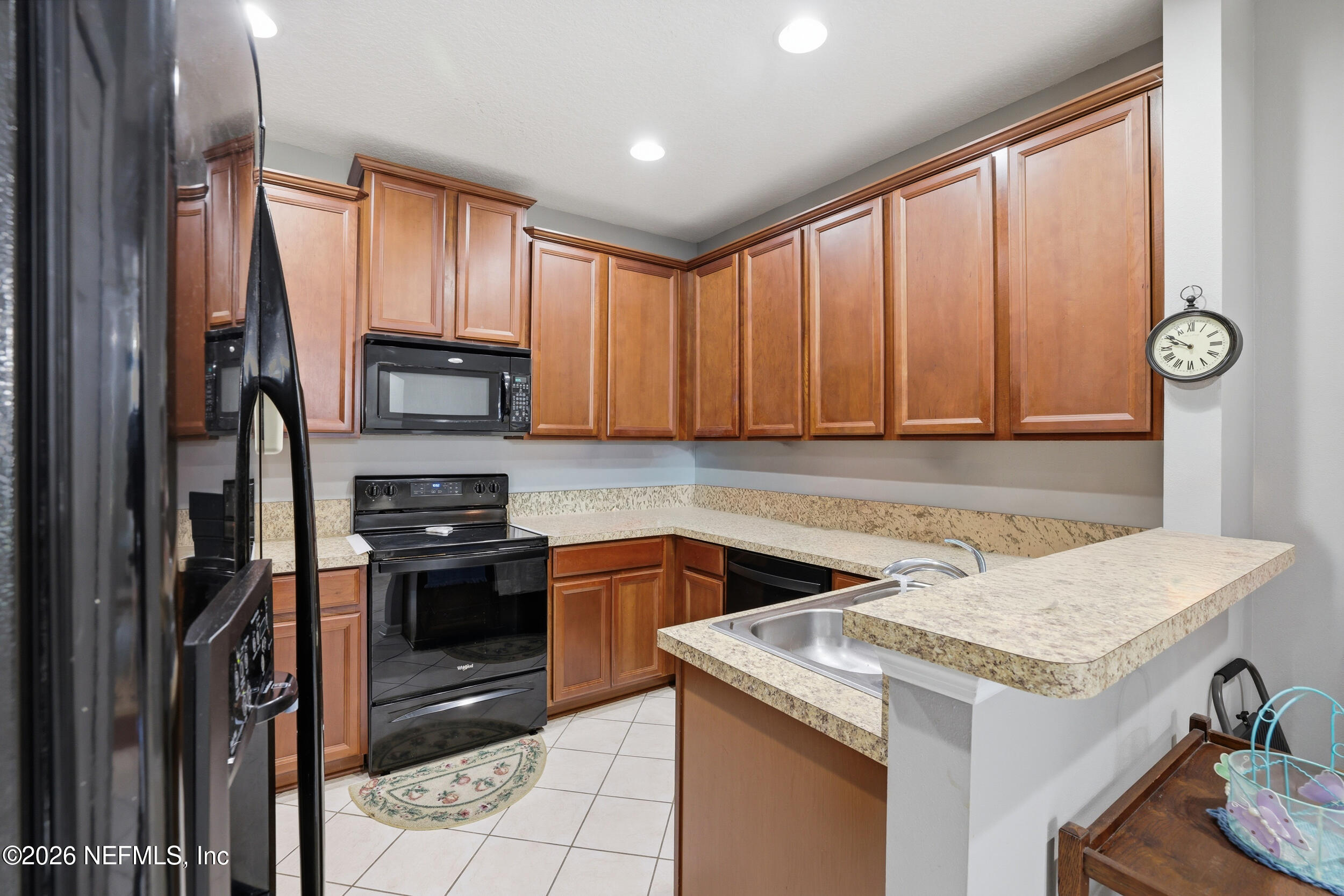 3260 Chestnut Ridge Way Orange Park, FL 32065 - Photo 9 of 39 a kitchen with a stove a sink and a refrigerator