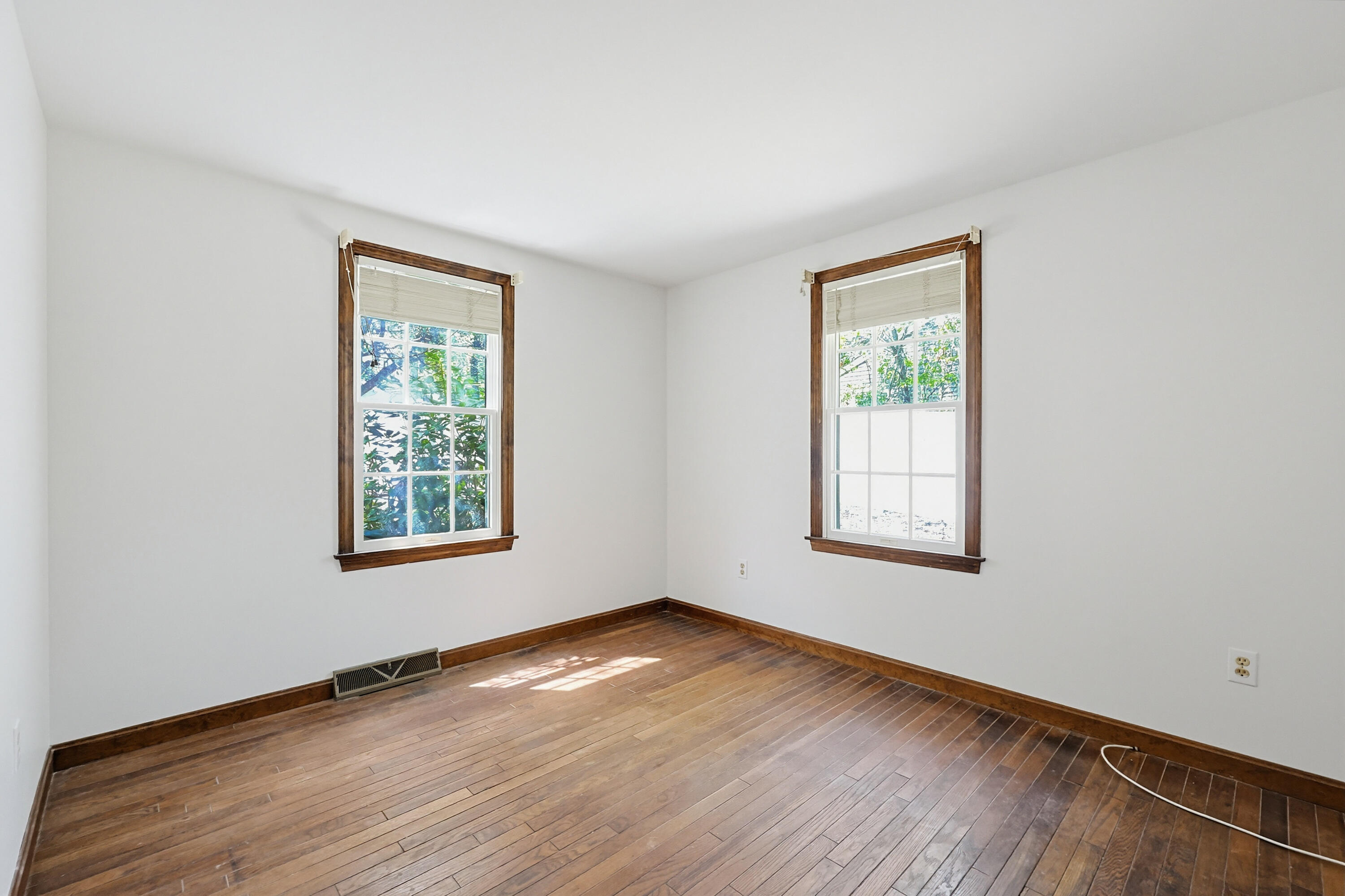 556 Cotuit Road Mashpee, MA 02649 - Photo 10 of 45 an empty room with wooden floor and windows