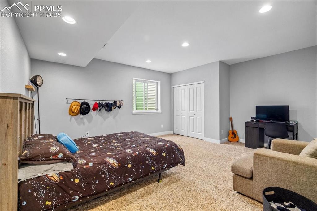 293 3rd Avenue Deer Trail, CO 80105 - Photo 16 of 28 a bedroom with a bed and a couch