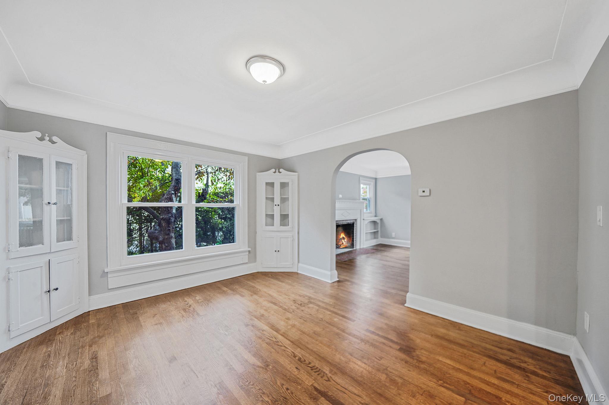 132 Duncan Road Hempstead, NY 11550 - Photo 11 of 21 an empty room with wooden floor and windows