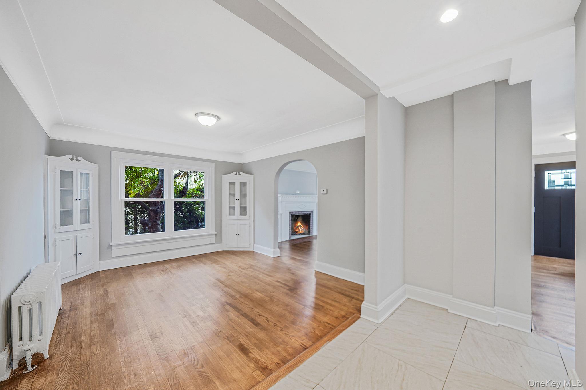 132 Duncan Road Hempstead, NY 11550 - Photo 12 of 21 a view of empty room with wooden floor and fireplace