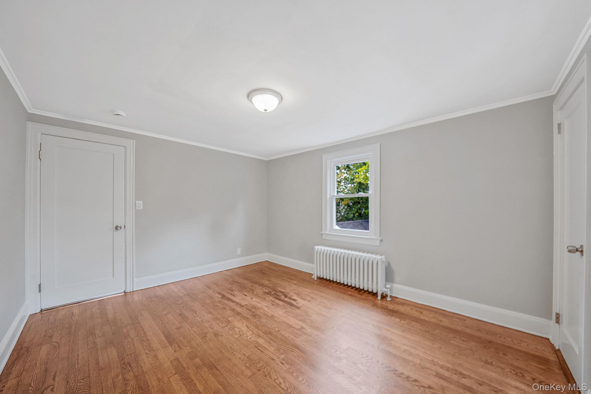 132 Duncan Road Hempstead, NY 11550 - Photo 17 of 21 a view of empty room with wooden floor and fan