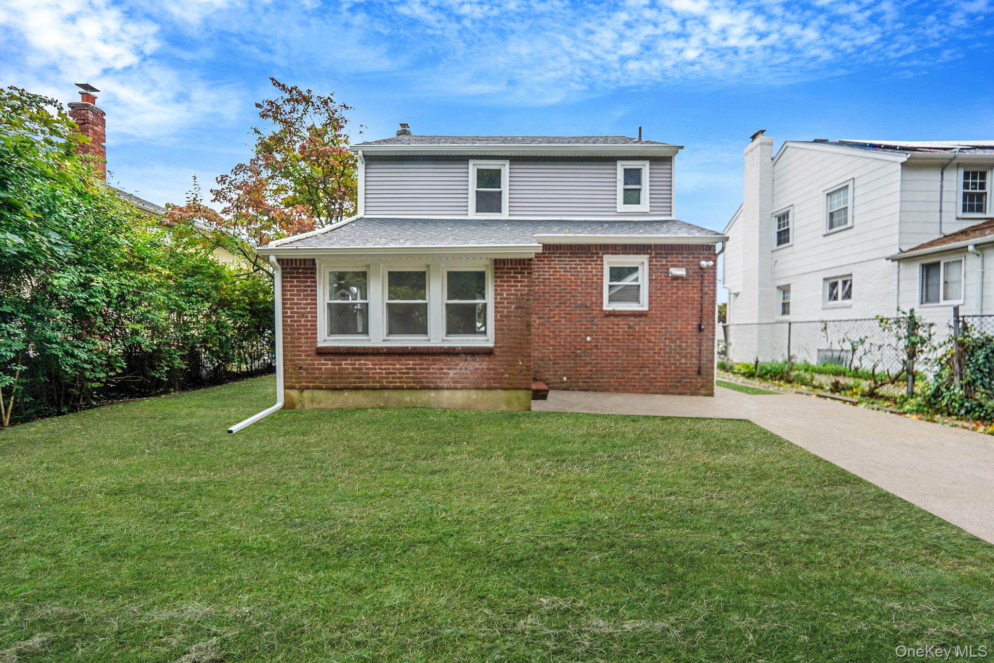 132 Duncan Road Hempstead, NY 11550 - Photo 4 of 21 a front view of a house with a garden