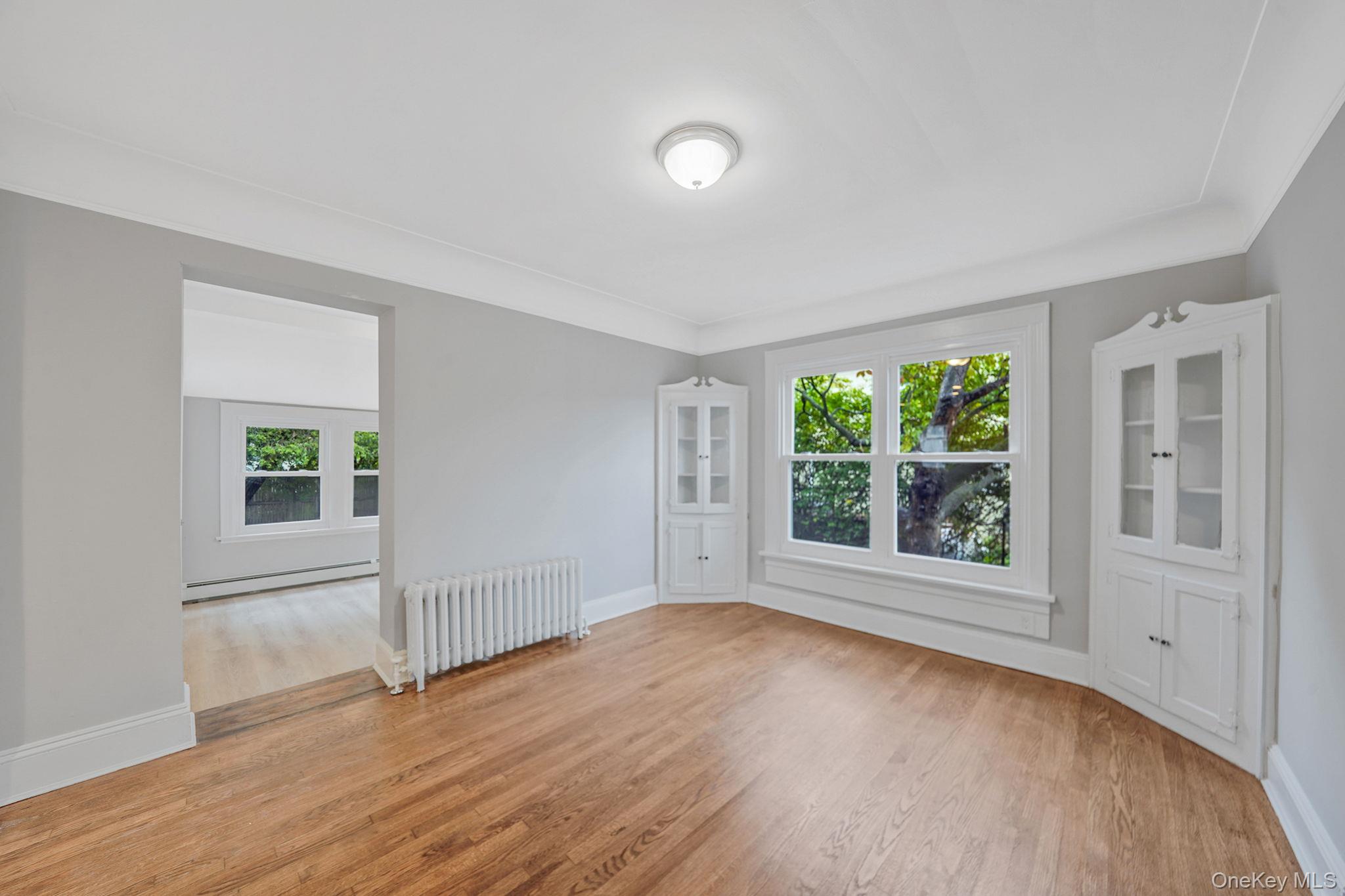 132 Duncan Road Hempstead, NY 11550 - Photo 10 of 21 an empty room with wooden floor and windows