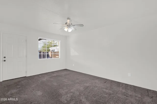 a view of a big room with wooden floor and windows in a room