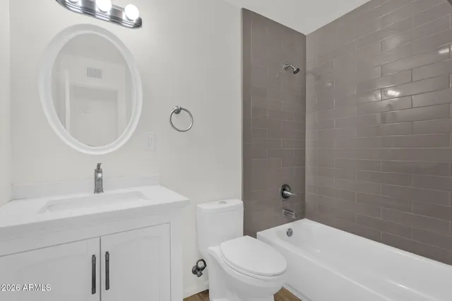 a bathroom with a sink a toilet and a mirror