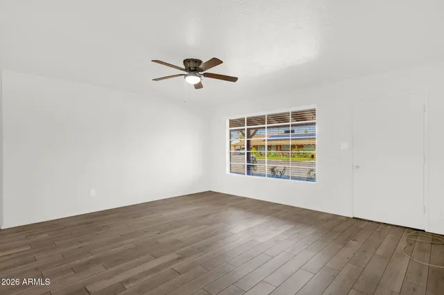 a view of room with hardwood floor and ceiling fan