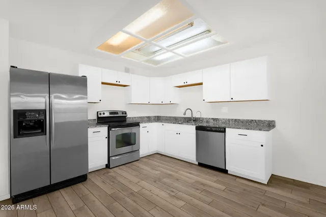 an empty room with a window and a ceiling fan