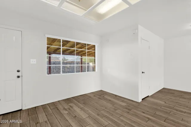 a view of a room with a ceiling fan and a window