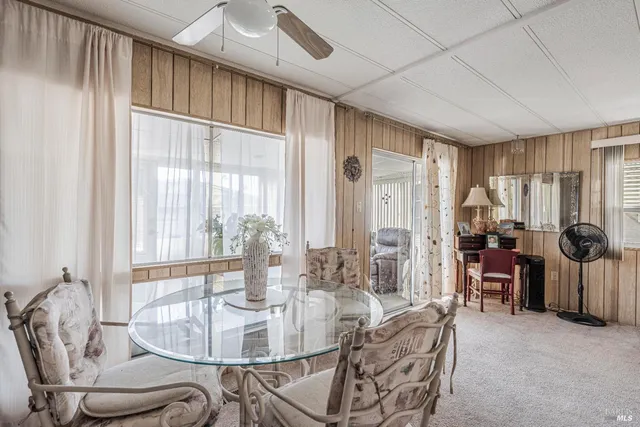 a dining room with furniture window and outside view