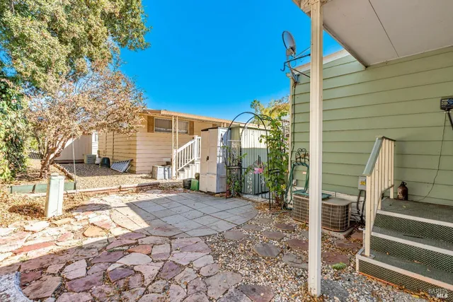 a backyard of a house with outdoor seating