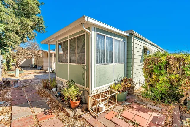 a view of an house with backyard space and garden