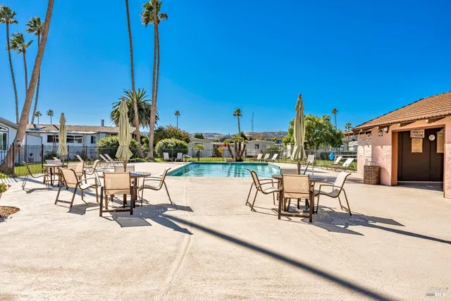 a bedroom with a bed and a table with chair