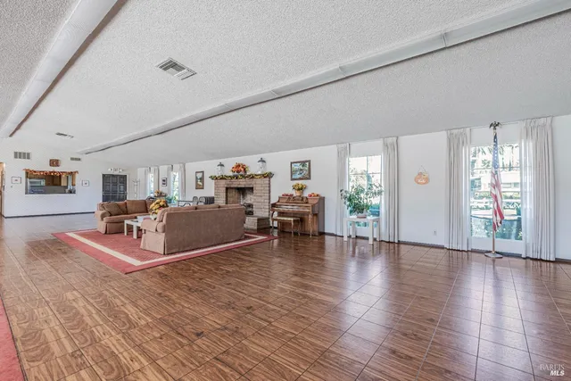 a living room with furniture a rug and a window