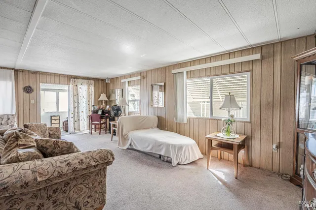 a bedroom with furniture and a large window