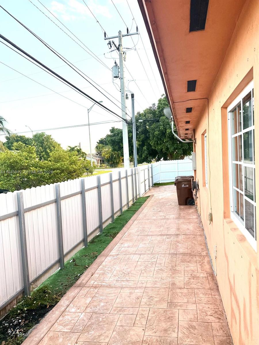 690 East 6th Place Hialeah, FL 33010 - Photo 18 of 18 a view of a porch with wooden floor and fence