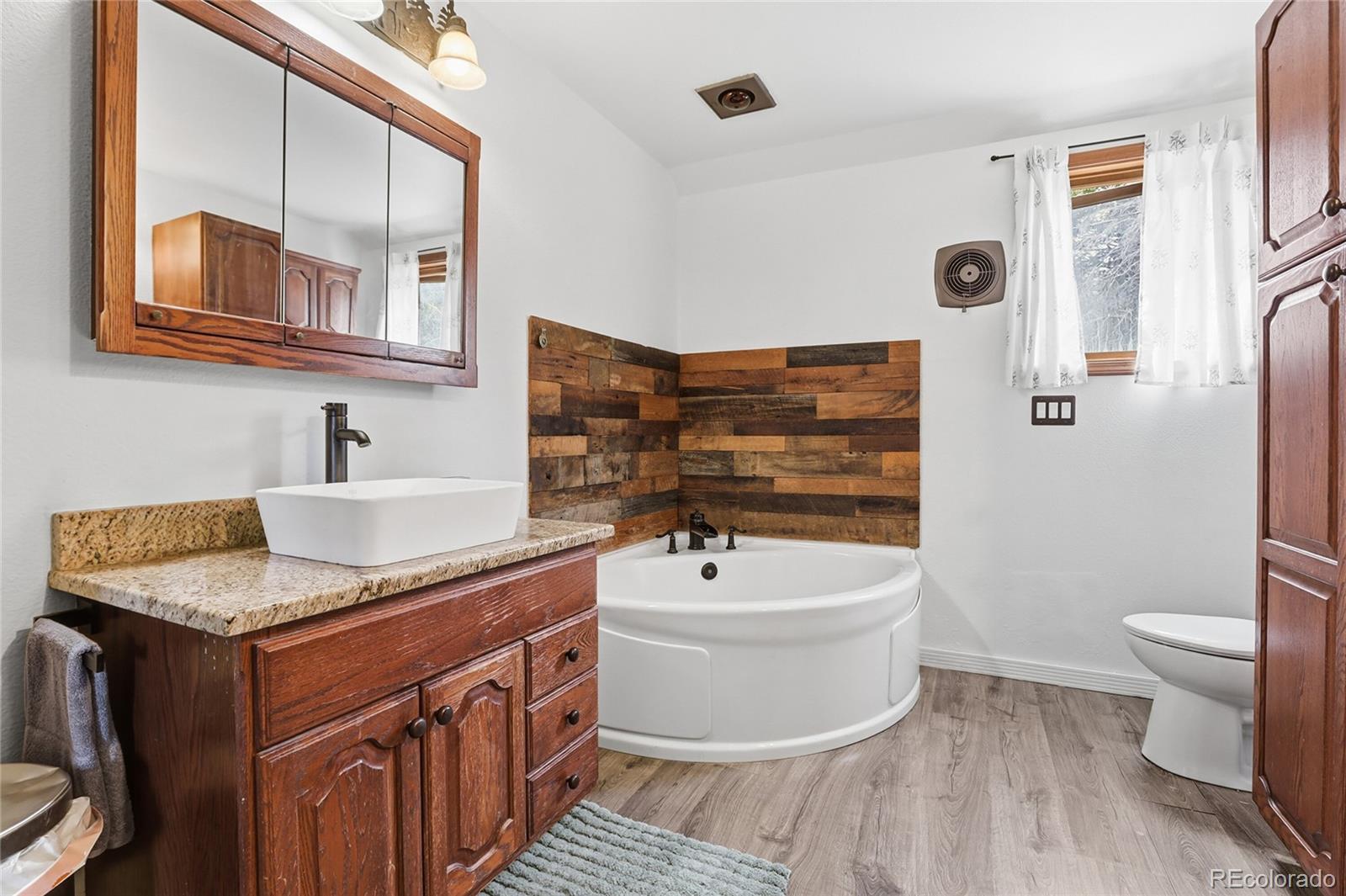 9225 Sandy Lane Conifer, CO 80433 - Photo 17 of 45 a bathroom with a sink a toilet and shower