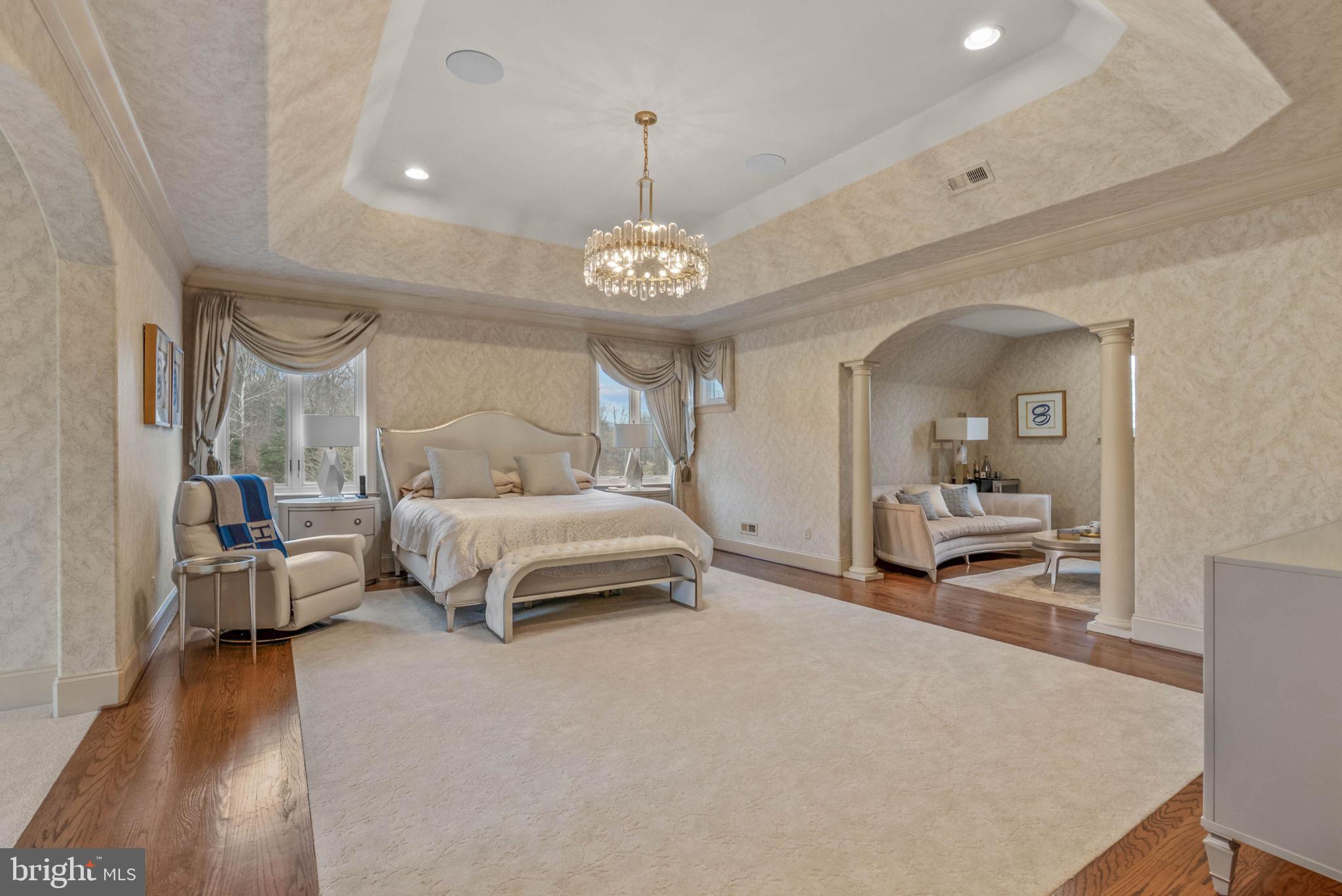 801 South Penn Oak Road Lower Gwynedd, PA 19002 - Photo 17 of 29 a bedroom with a large bed and a chandelier