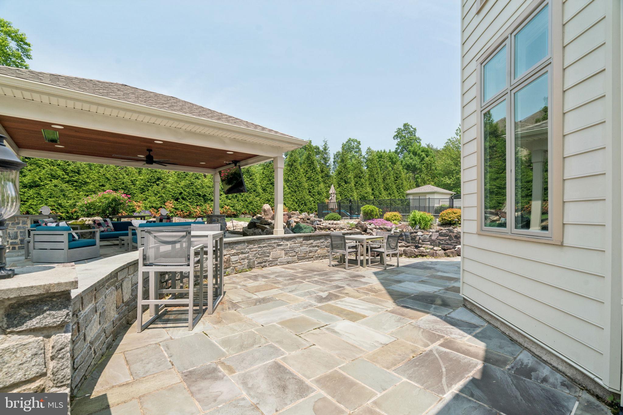 801 South Penn Oak Road Lower Gwynedd, PA 19002 - Photo 37 of 114 a view of a patio with a table and chairs and potted plants