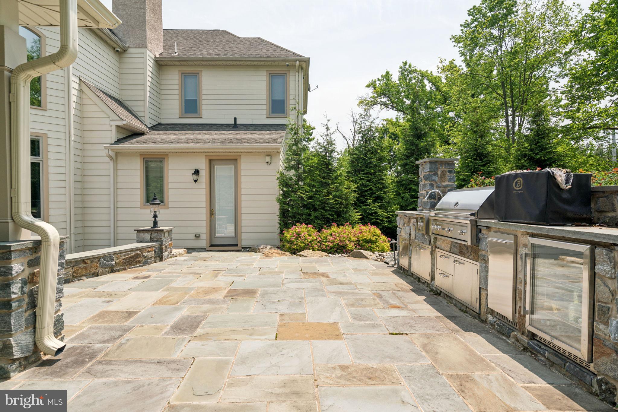 801 South Penn Oak Road Lower Gwynedd, PA 19002 - Photo 40 of 114 a backyard of a house with barbeque oven and outdoor seating