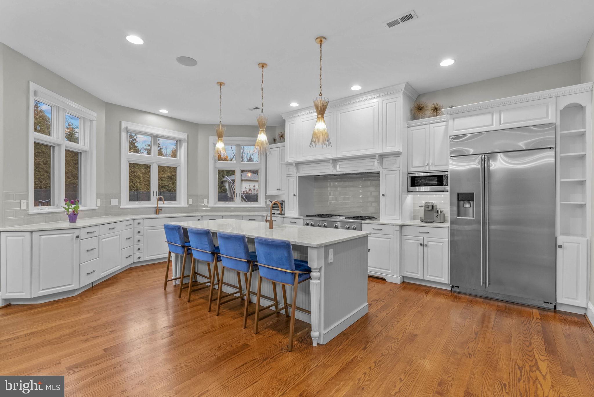 801 South Penn Oak Road Lower Gwynedd, PA 19002 - Photo 8 of 29 a kitchen with stainless steel appliances granite countertop a stove a refrigerator a oven a sink with a dining table and chairs