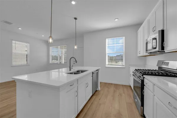 a view of a kitchen with a sink and a refrigerator