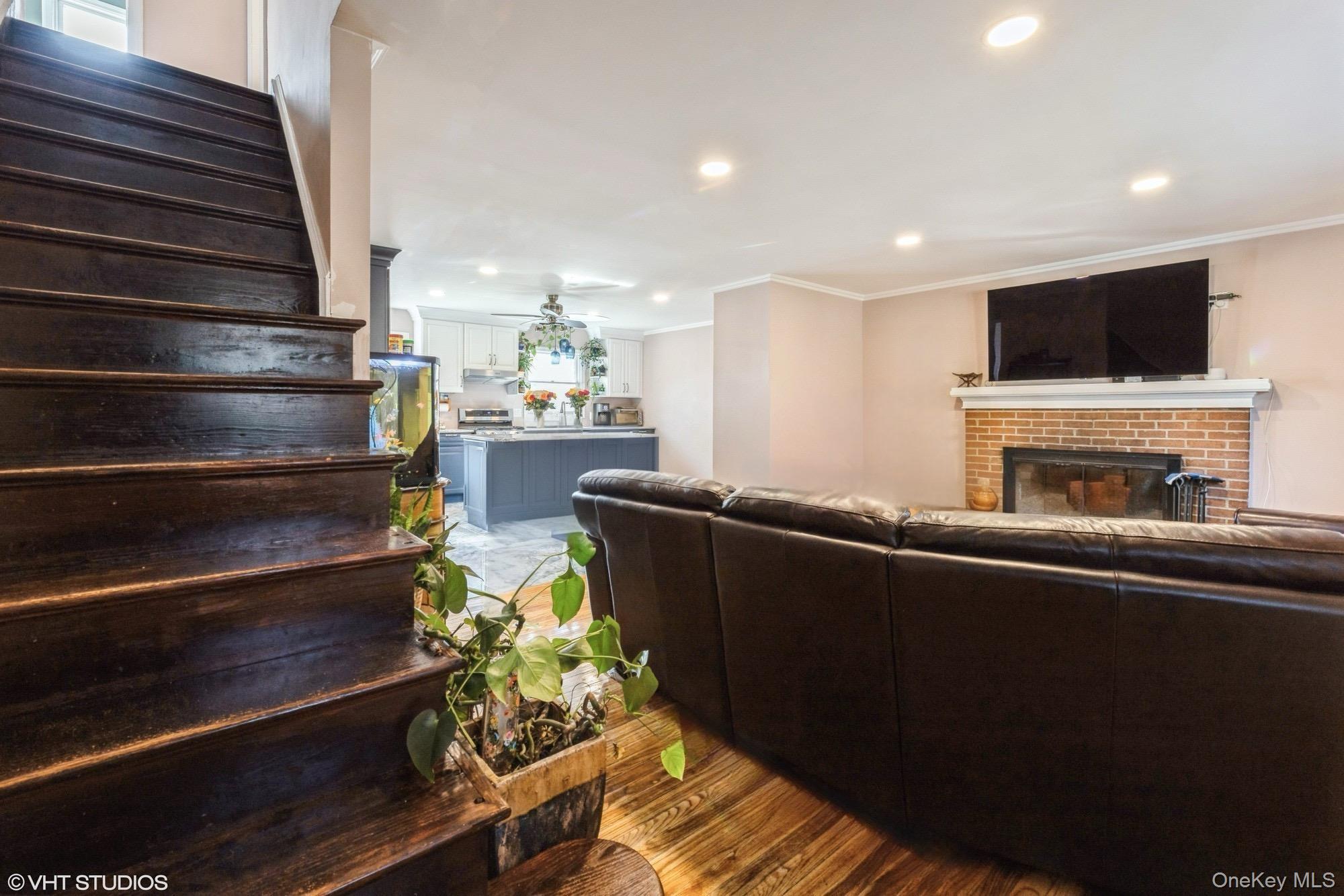 289 Quaker Road Pomona, NY 10970 - Photo 12 of 30 a living room with furniture a flat screen tv and kitchen view