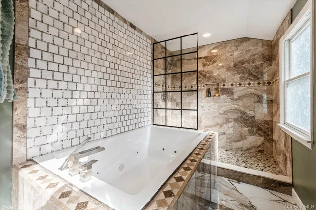 a bathroom with a bathtub and shower