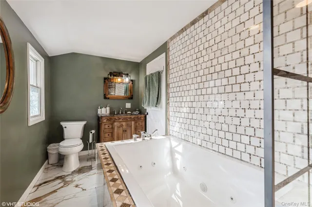 a bathroom with a bathtub and a toilet