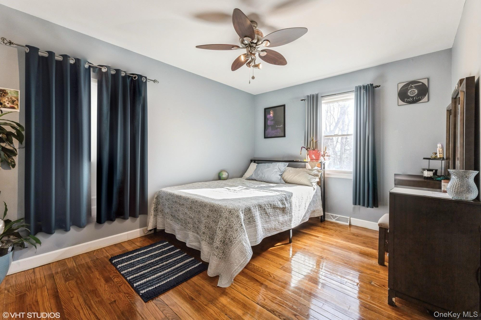 289 Quaker Road Pomona, NY 10970 - Photo 8 of 30 a bedroom with a bed and a chandelier