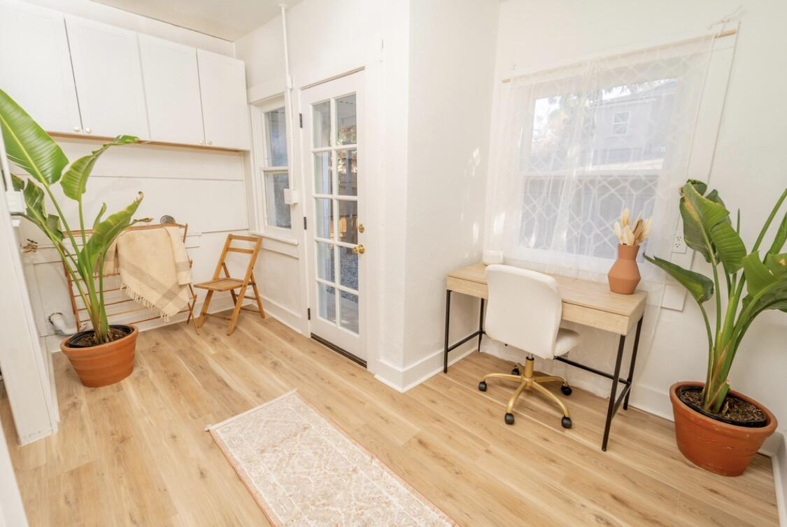 232 Ash Street Exeter, CA 93221 - Photo 9 of 13 a view of a workspace with furniture and a potted plant