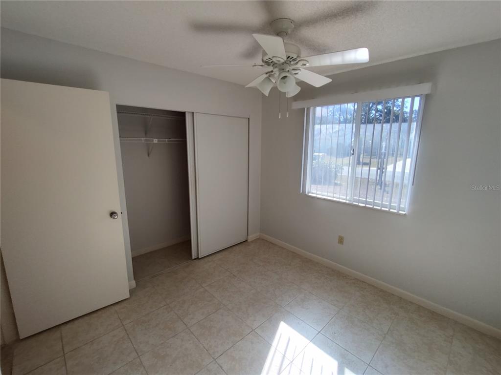 8491 Southwest 109th Street Ocala, FL 34481 - Photo 17 of 39 a view of an empty room with chandelier fan and fire place