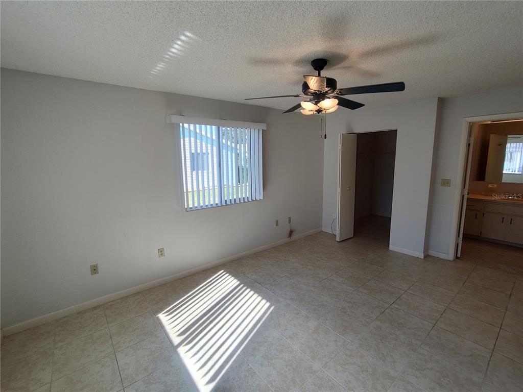 8491 Southwest 109th Street Ocala, FL 34481 - Photo 22 of 39 an empty room with chandelier fan and windows
