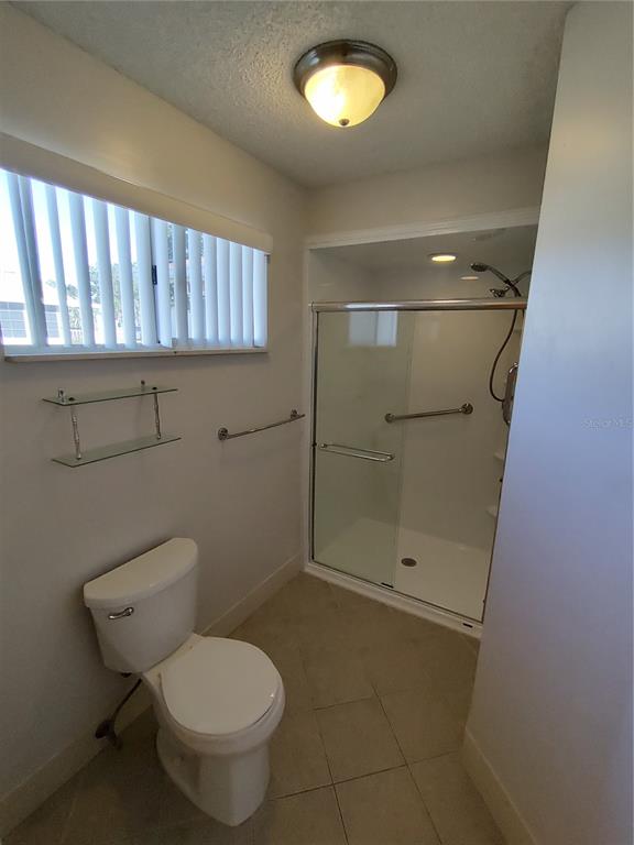 8491 Southwest 109th Street Ocala, FL 34481 - Photo 25 of 39 a bathroom with a toilet and a shower