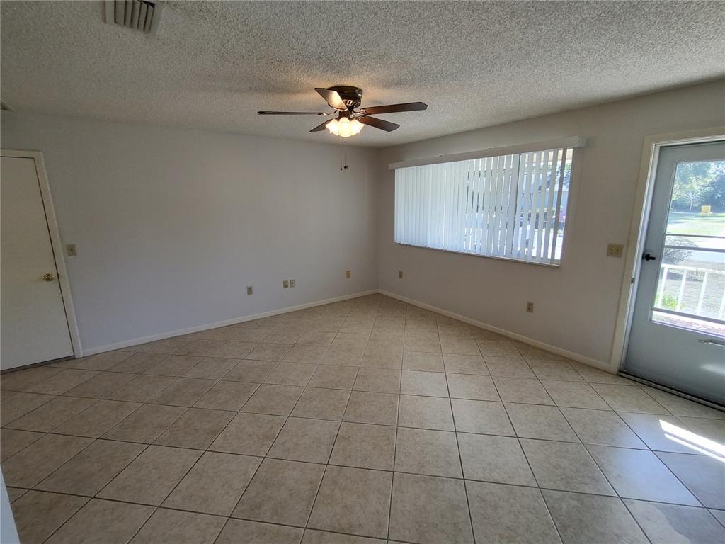 8491 Southwest 109th Street Ocala, FL 34481 - Photo 5 of 39 a view of an empty room with a window