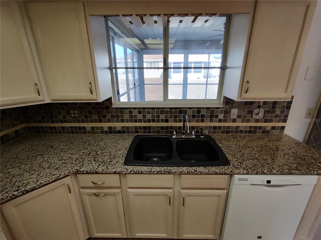 8491 Southwest 109th Street Ocala, FL 34481 - Photo 9 of 39 a kitchen with granite countertop a sink and a stove