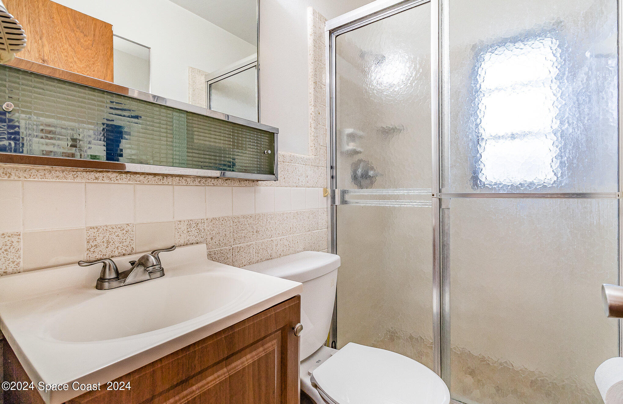 1707 Platt Street Melbourne, FL 32901 - Photo 16 of 32 a bathroom with a sink toilet and shower