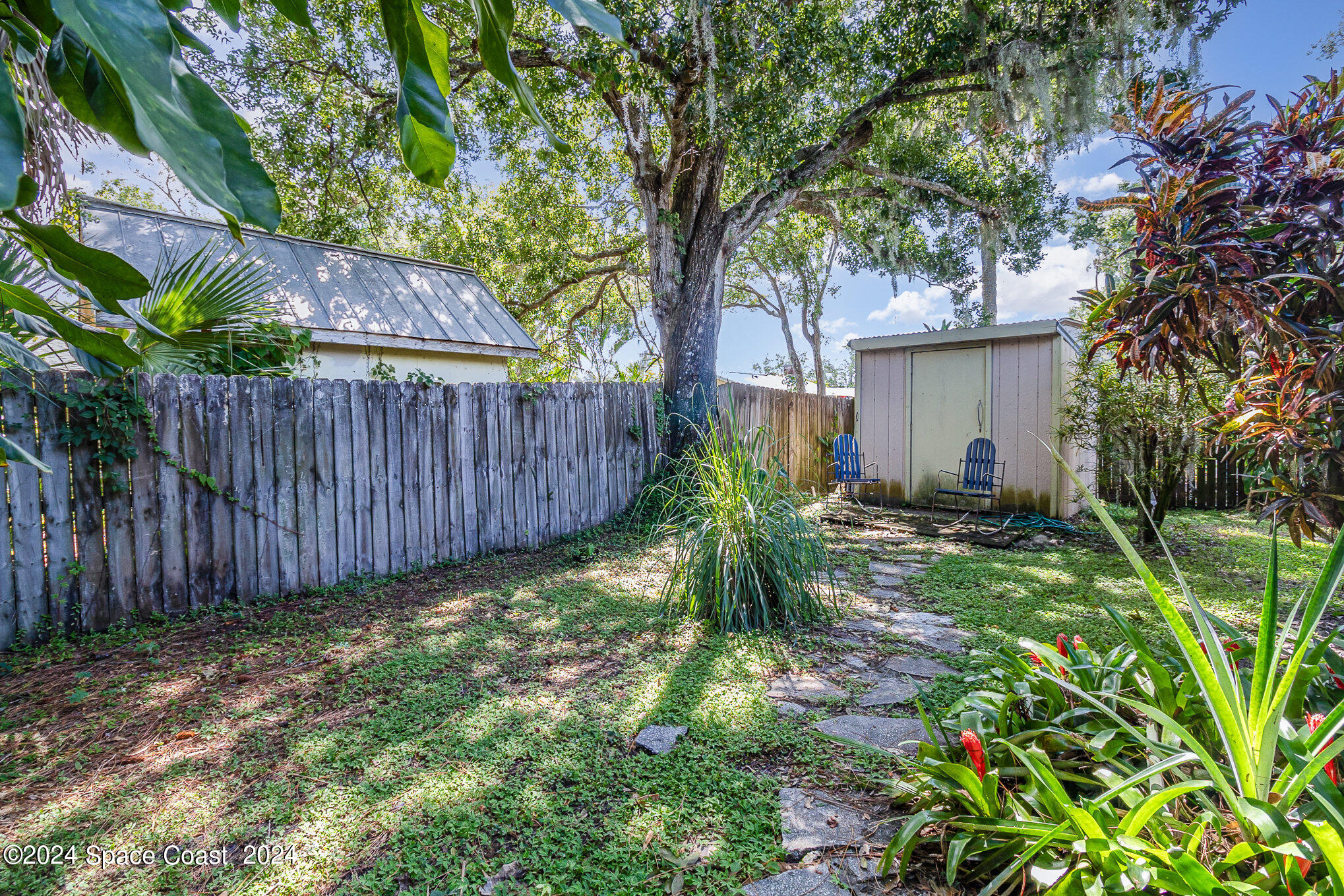 1707 Platt Street Melbourne, FL 32901 - Photo 21 of 32 a view of a backyard with plants and large trees