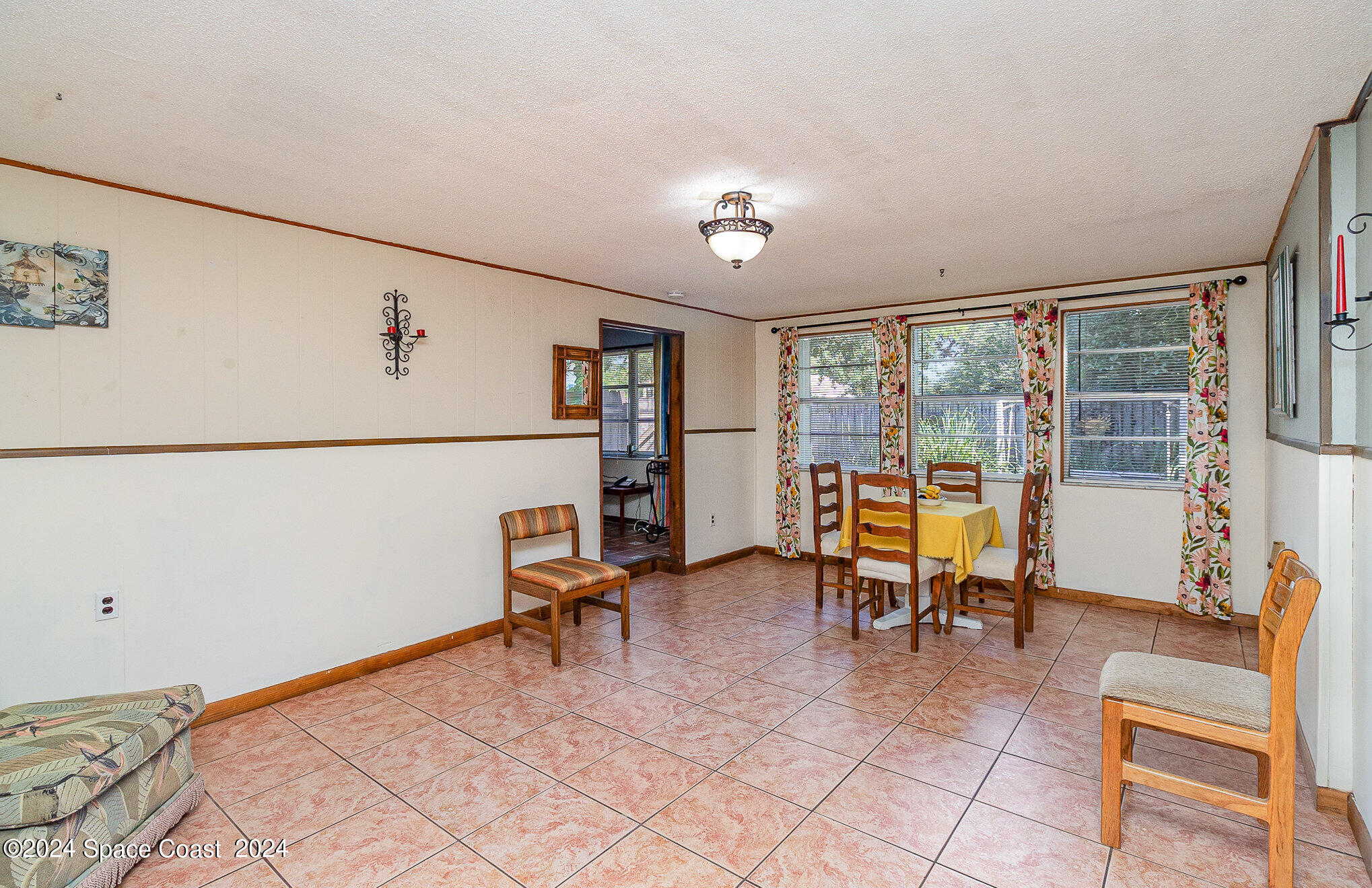 1707 Platt Street Melbourne, FL 32901 - Photo 7 of 32 a room with furniture and a refrigerator